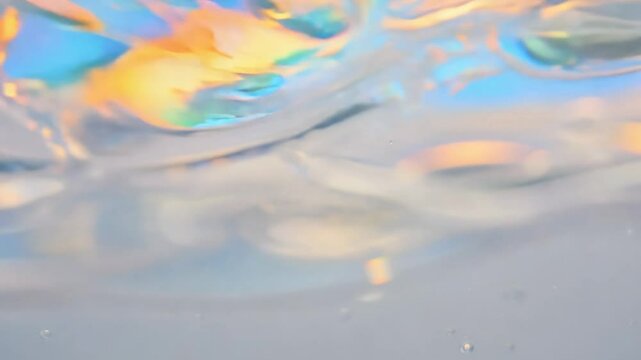 Seamless loop video of soap bubbles floating on water with rainbow reflections. static video with soft lighting, focus on iridescent colors and delicate movements