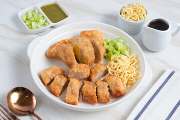 Pempek, traditional food from South Sumatra, Indonesia. This fish-based food is very popular. Served with cuko sauce and cucumber slices. Perfect for recipe, article, catalogue.