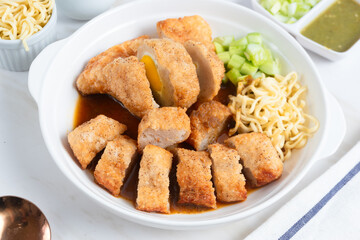 Pempek, traditional food from South Sumatra, Indonesia. This fish-based food is very popular. Served with cuko sauce and cucumber slices. Perfect for recipe, article, catalogue.