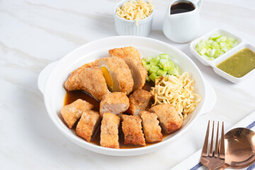 Pempek, traditional food from South Sumatra, Indonesia. This fish-based food is very popular. Served with cuko sauce and cucumber slices. Perfect for recipe, article, catalogue.