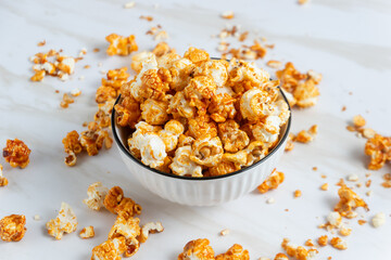 caramel popcorn in a white bowl. Perfect for recipe, article, catalogue, or any commercial purposes. with copy space.