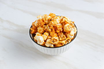 caramel popcorn in a white bowl. Perfect for recipe, article, catalogue, or any commercial purposes. with copy space.
