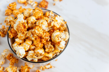 caramel popcorn in a white bowl. Perfect for recipe, article, catalogue, or any commercial purposes. with copy space.
