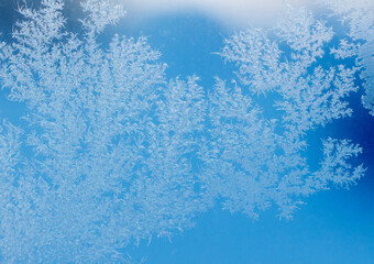 Frost patterns on window glass. Cold winter background