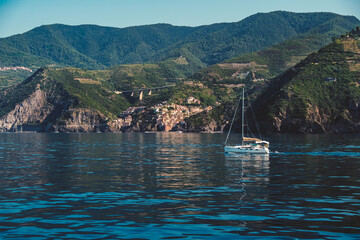 coast of Riomaggiore with a sailboat in Cinque Terre