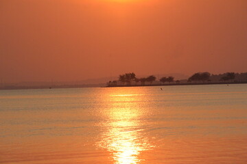 reddish orange sunrise on the morning beach