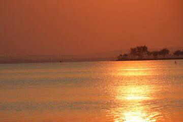 reddish orange sunrise on the morning beach