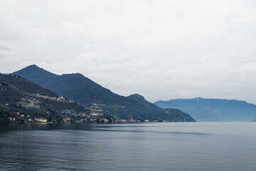 Fototapeta premium Cloudy sky above blue mountain vista, lake Como, Italy