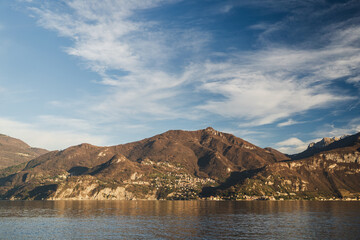 Mountain range against dramatic blue sky with white clouds