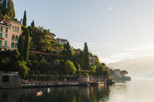 Coastal view of colourful Varenna against blue sky on sunny day