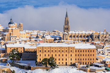 Snow over cathedral & old buildings, town world heritage site