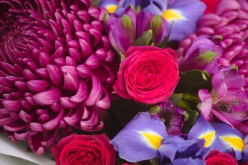 Close-up shot of a bouquet of roses, irises, chrysanthemums and alstroemerias