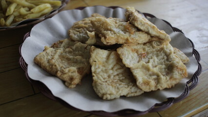 a plate of fried tempeh or mendoan, a typical Indonesian food made from soybeans, served with other...