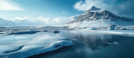 Majestic Icelandic landscape showcasing glaciers, mountains, and serene waters under a clear blue sky in a pristine natural environment.