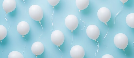 White balloons scattered on a soft pastel blue background creating a festive and cheerful atmosphere for celebrations and events