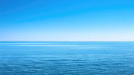 Fototapeta premium Tranquil Blue Ocean Under Clear Sky with Endless Horizon View