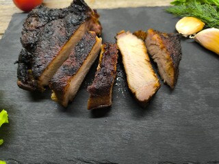 Delicious fried steak cut into pieces on a granite edged board