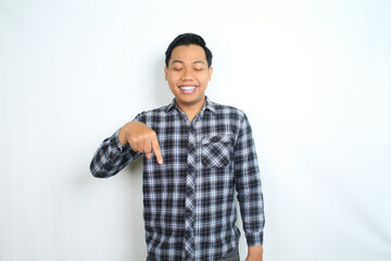 Fototapeta premium happy asian man pointing hand with smiling face and confident gesture isolated on white backgroun wearing plaid shirt