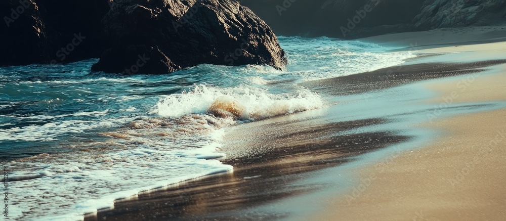 Poster serene beach landscape with gentle waves lapping at the sandy shore and rugged rocks under soft sunl