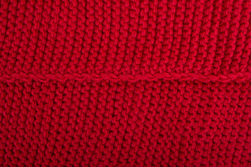 Woolen knitted background. Red textured sweater Christmas Fabric