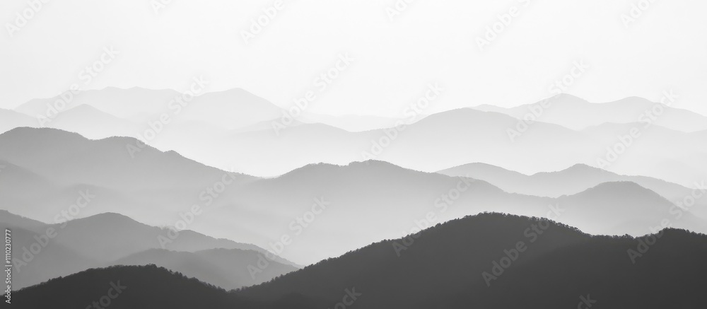 Poster serene monochrome mountain landscape with layered peaks and soft mist creating a peaceful atmospheri
