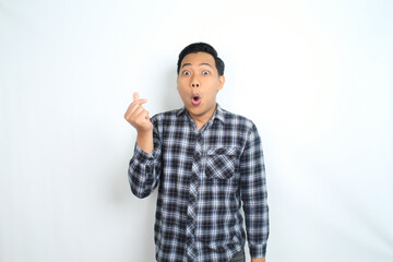Fototapeta premium asian man showing mini heart shape using finger with shocked and funny face wow expression isolated on white