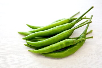 Green chili,spur chilli, spur chili pepper, spur pepper, long  green pepper on white background