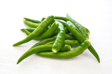 Green chili,spur chilli, spur chili pepper, spur pepper, long  green pepper on white background