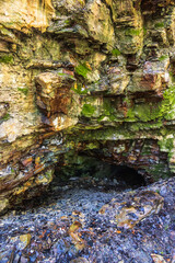 Rock face with a entrance to a cave