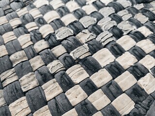 The background texture and pattern of the floor mat are made from white and dark blue patchwork