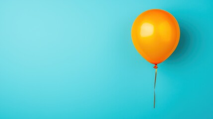 A vibrant orange balloon floats against a bright blue background, creating a cheerful and festive atmosphere.