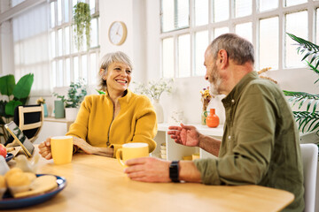 Senior couple enjoying coffee and conversation at home