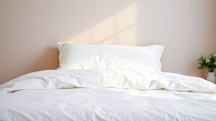 Crisp white bedding on a bed, bathed in sunlight against a muted pink wall, creating a serene and restful atmosphere