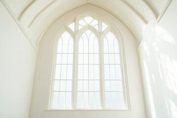 Large arched window, white walls, vaulted ceiling.