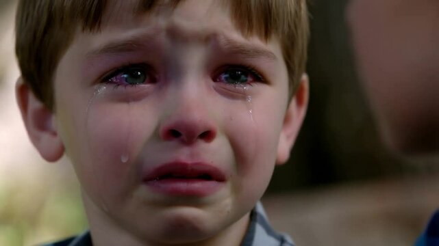 Young boy crying potentially being told off