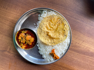 Fish curry thali served with papad