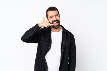 Young man with beard over isolated white background making phone gesture. Call me back sign