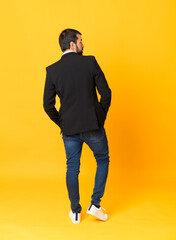 Fototapeta premium Full-length shot of business man over isolated yellow background