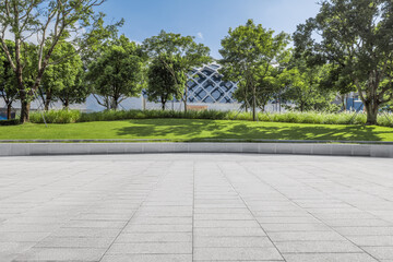 Empty brick floor and woods and grass background