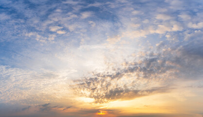 panoramic view of a sunset or sunrise showcasing vibrant hues of orange as the sun dips below the horizon nature background