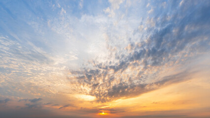 The sky is adorned with wispy clouds, creating a dramatic and serene atmosphere of a sunset or sunrise nature background