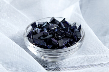 Semi-precious gemstone night cairo dark blue natural Aventurine stone on a light gray background close up