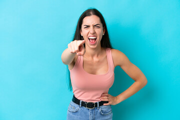 Fototapeta premium Young caucasian woman isolated on blue background frustrated and pointing to the front