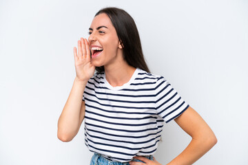 Fototapeta premium Young caucasian woman isolated on white background shouting with mouth wide open to the side