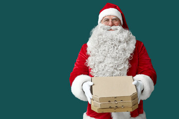 Santa Claus with pizza boxes on green background