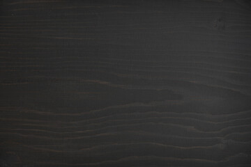 black wood stain wooden background showing knots and texture