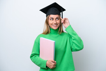 Young university graduate woman isolated on white background having doubts and thinking