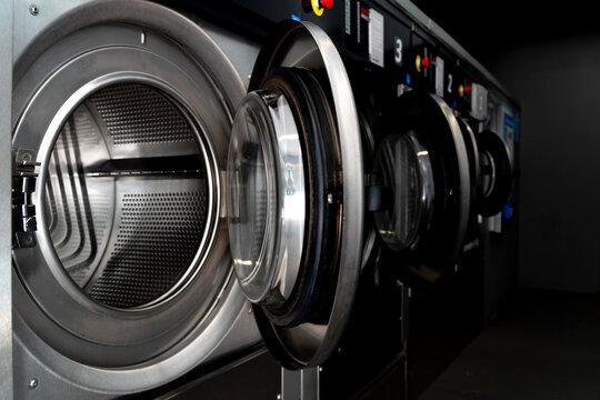 Industrial washing machines in a modern laundromat setting