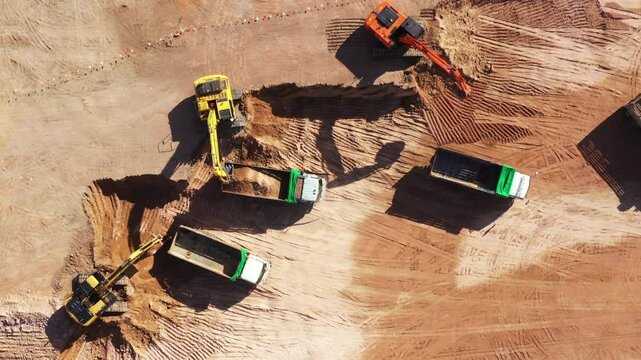 Aerial view road motor grader flatting dirt road surface, Motor grader road construction grader industrial machine construction site new road, Aerial view group excavator working on construction site.