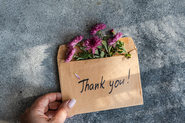 Envelope with flowers and handwritten thank you message
